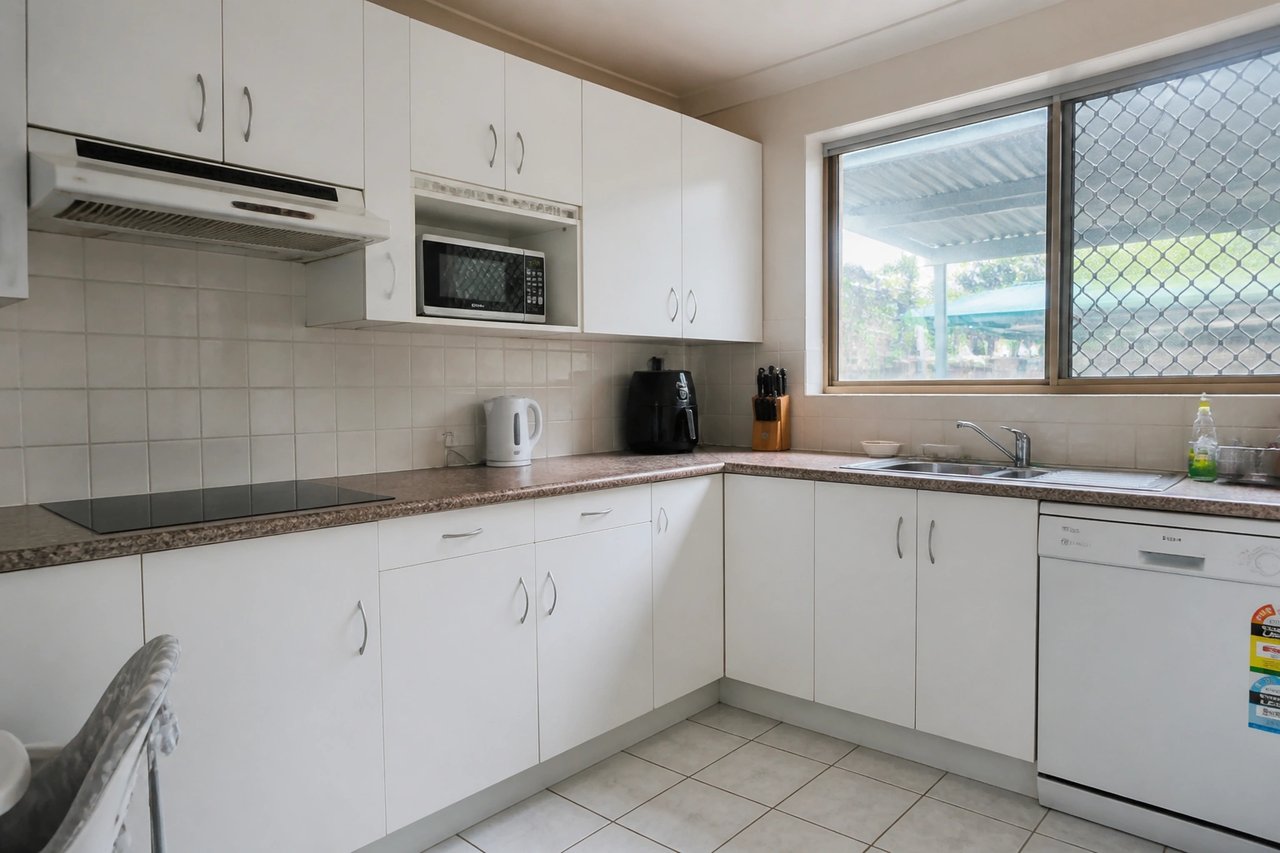 Plain white melamine kitchen cabinets before AI redesign
