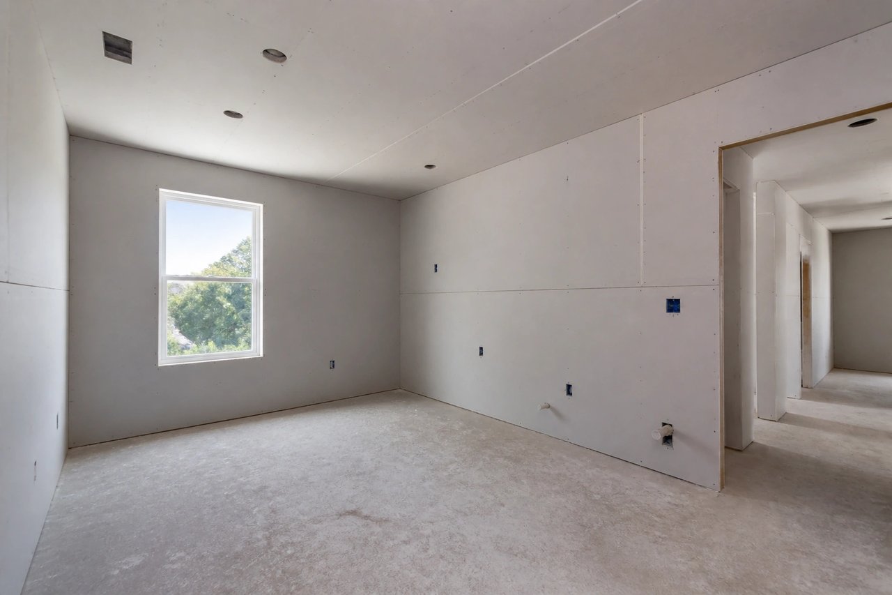 Drywall-stage room under construction before AI finish