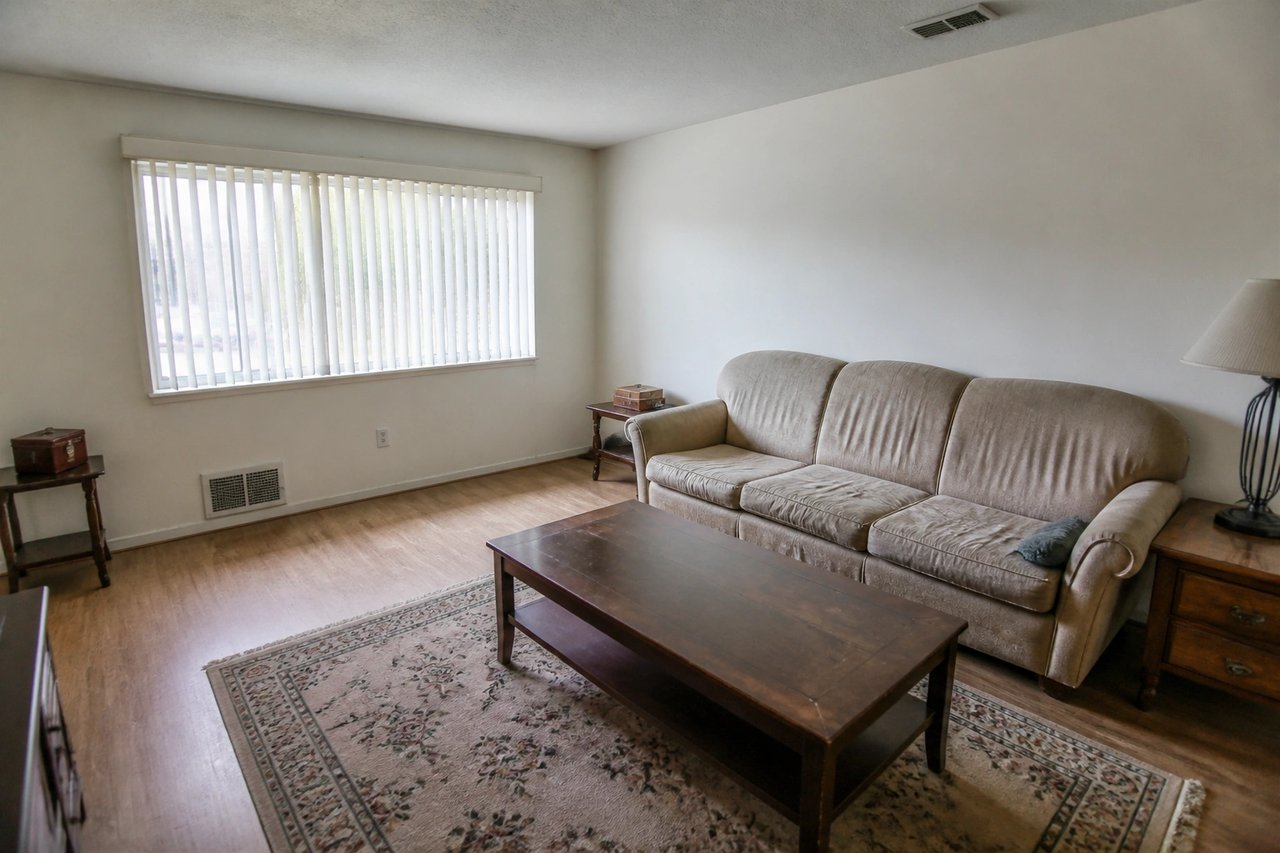 Living room with dated furniture before AI replacement